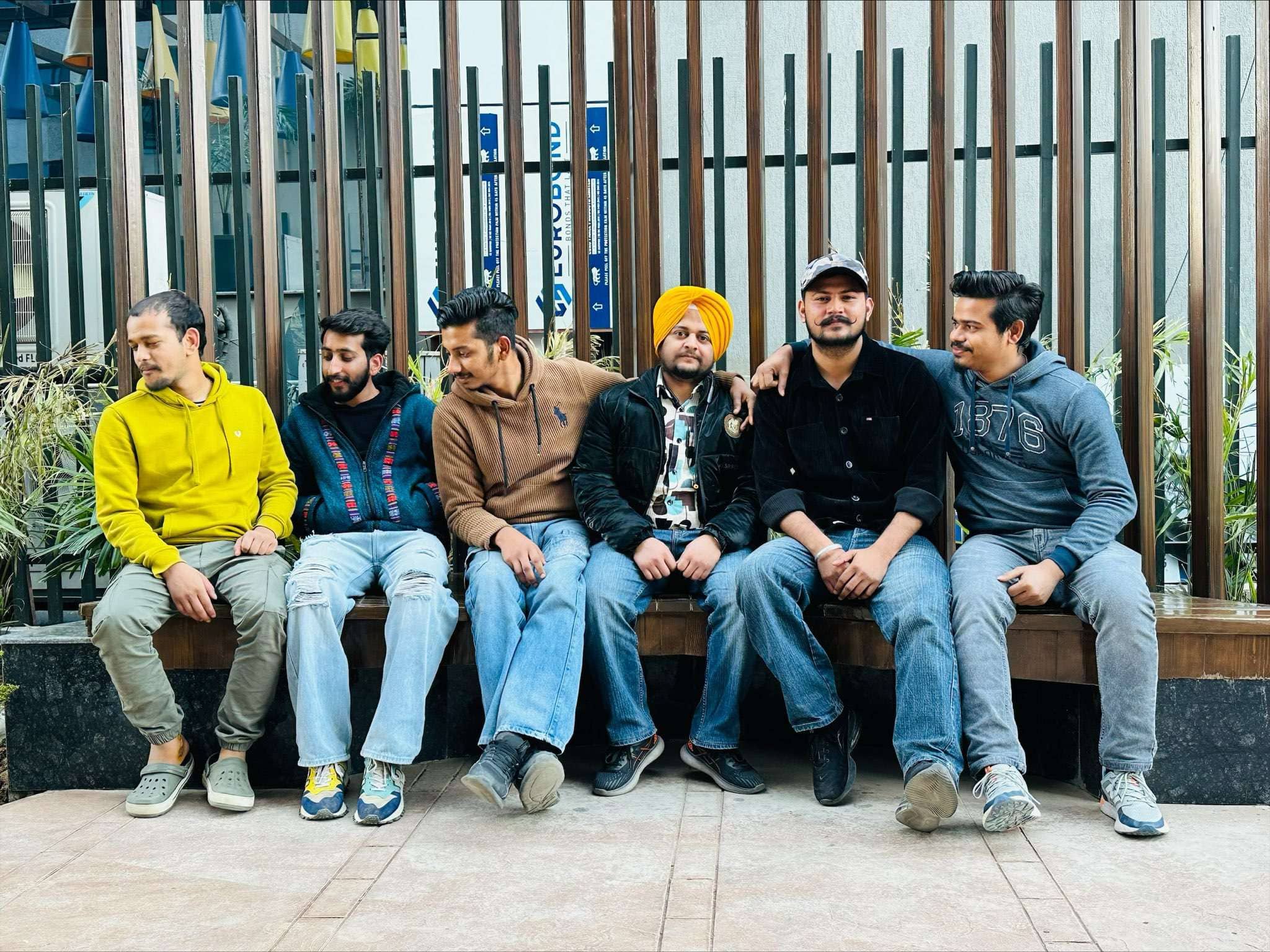 Whizcamp developers enjoying a relaxed outdoor team bonding moment on a bench