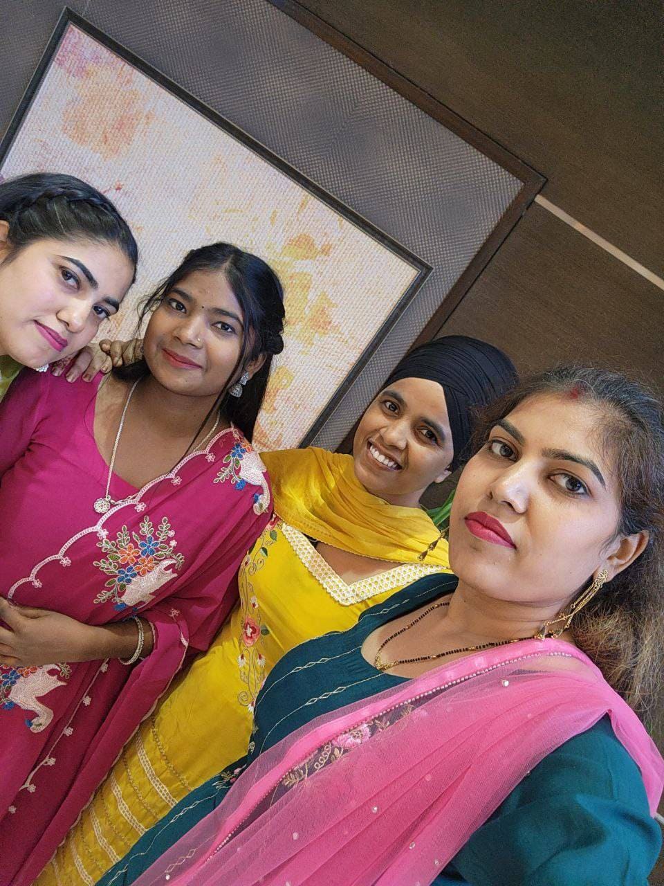 Whizcamp female team members smiling in a colorful festive selfie
