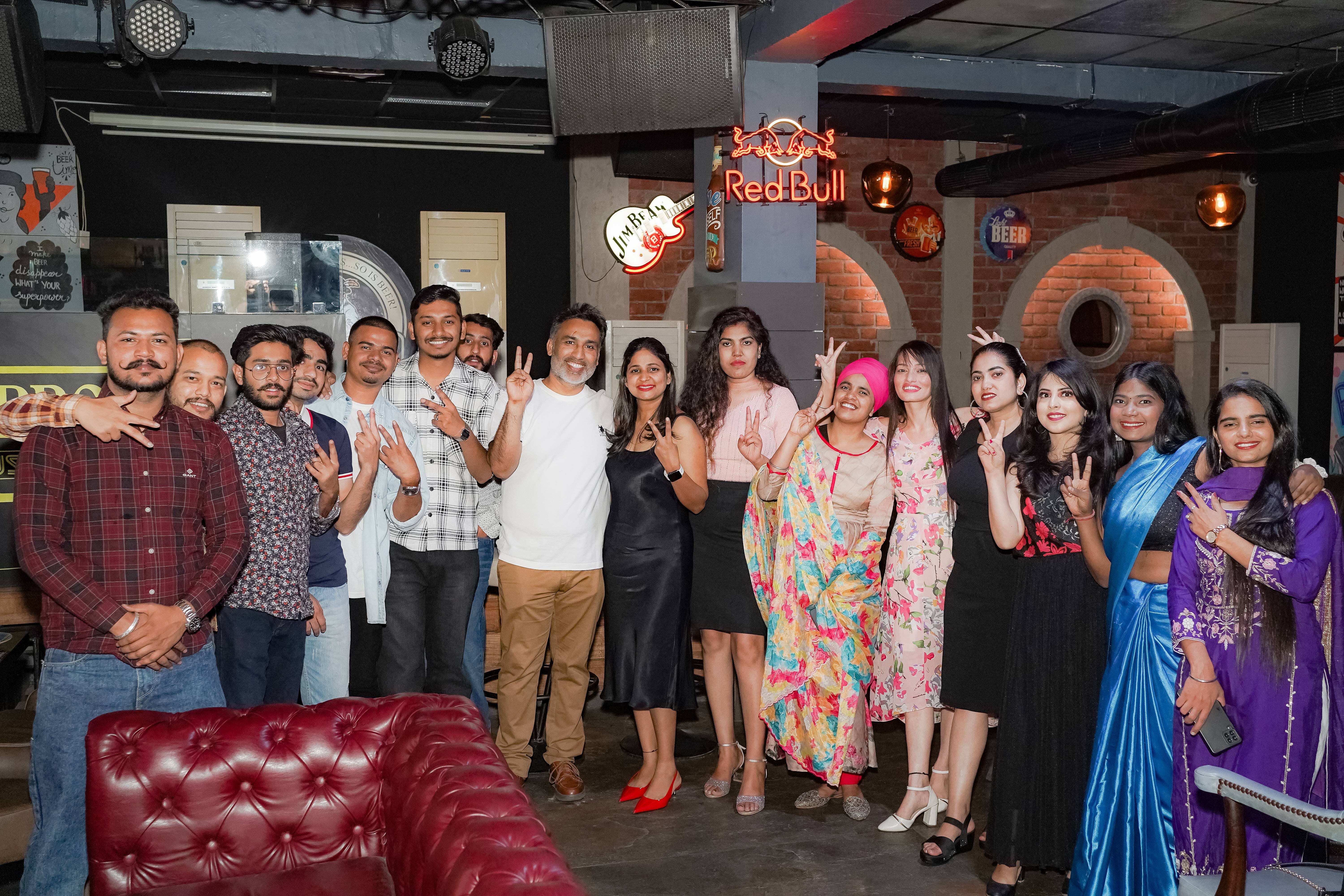 Full Whizcamp team posing together during a night event at Brew Bros